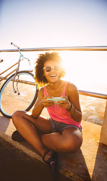 istock Girl with mobile phone near beach 486005021