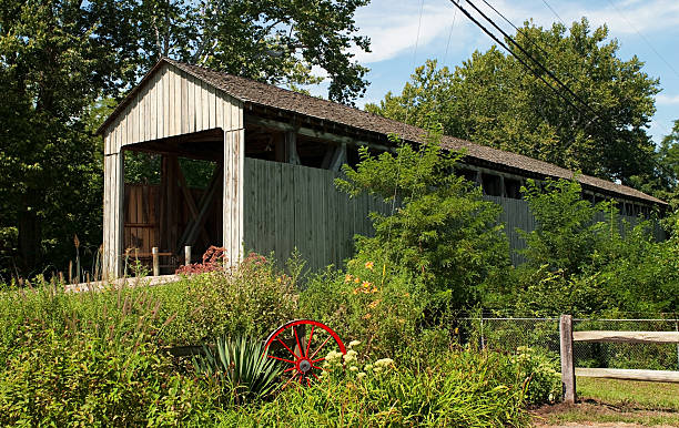 Old Wooden Covered Bridge This historic wooden bridge, Black (Pugh's Mill) Covered Bridge, was built in1868 just outside of Oxford, Ohio. It was restored in 2000. It is the longest covered bridge in Ohio at 209 feet long. oxford ohio photos stock pictures, royalty-free photos & images
