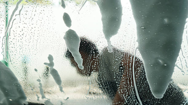 istock man washing a car, picture from inside a car 486008322