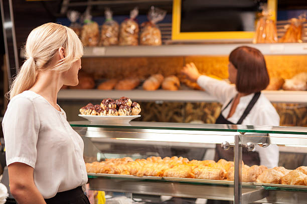 istock Experienced female baker is selling baked products 486010740