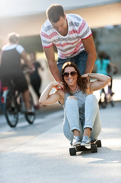 istock Couple skateboarding in the city 486014636
