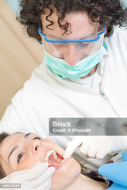 Dentist With Pipe Cleaner Stock Photo - Download Image Now - 20-29 Years, 40-44 Years, Adult