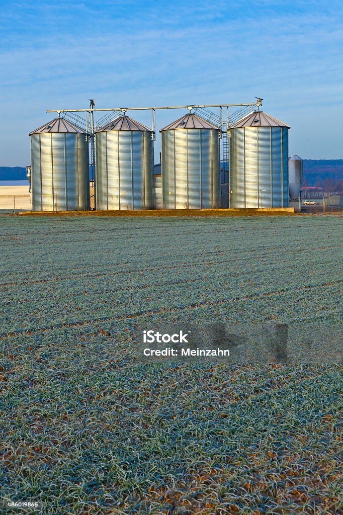 silos in the middle of a field in wintertime Agricultural Field Stock Photo