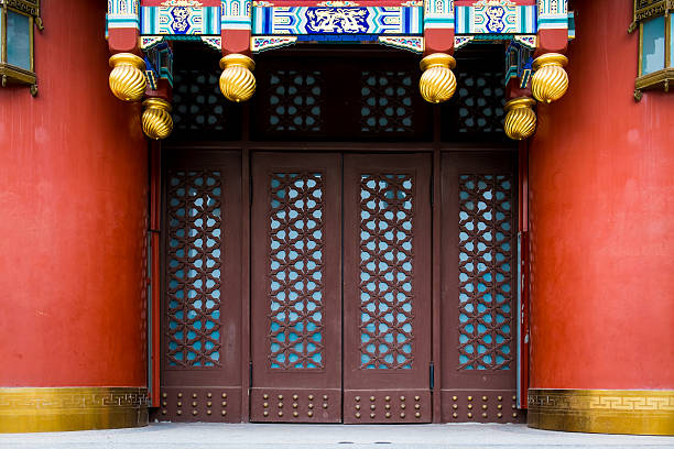 Vintage Chinese gateway with wooden folding doors.