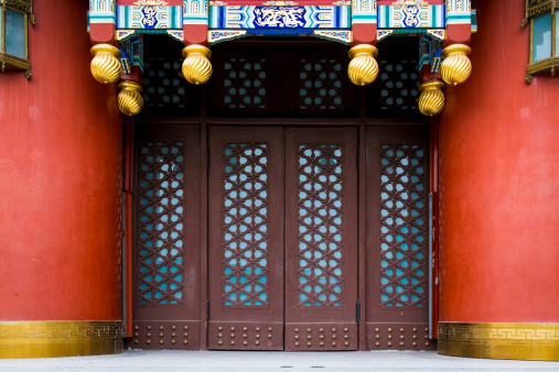 Vintage Chinese gateway with wooden folding doors.