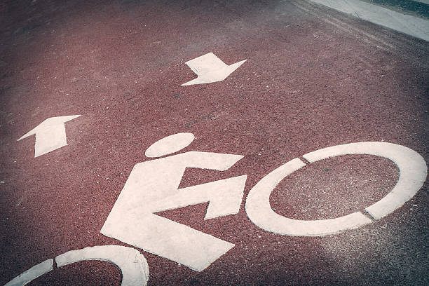 istock Bicycle lane or path, icon symbol on red asphalt road 486022196