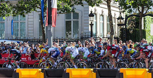 The Peloton in Paris  Paris,France, July 22nd 2012: The peloton riding during the final stage of Le Tour de France 2012 on Avenue des Champs Elysees in Paris.The British Nradley Wiggins wear the Yellow Jersey and won the competition in 2012. cycling vest photos stock pictures, royalty-free photos & images