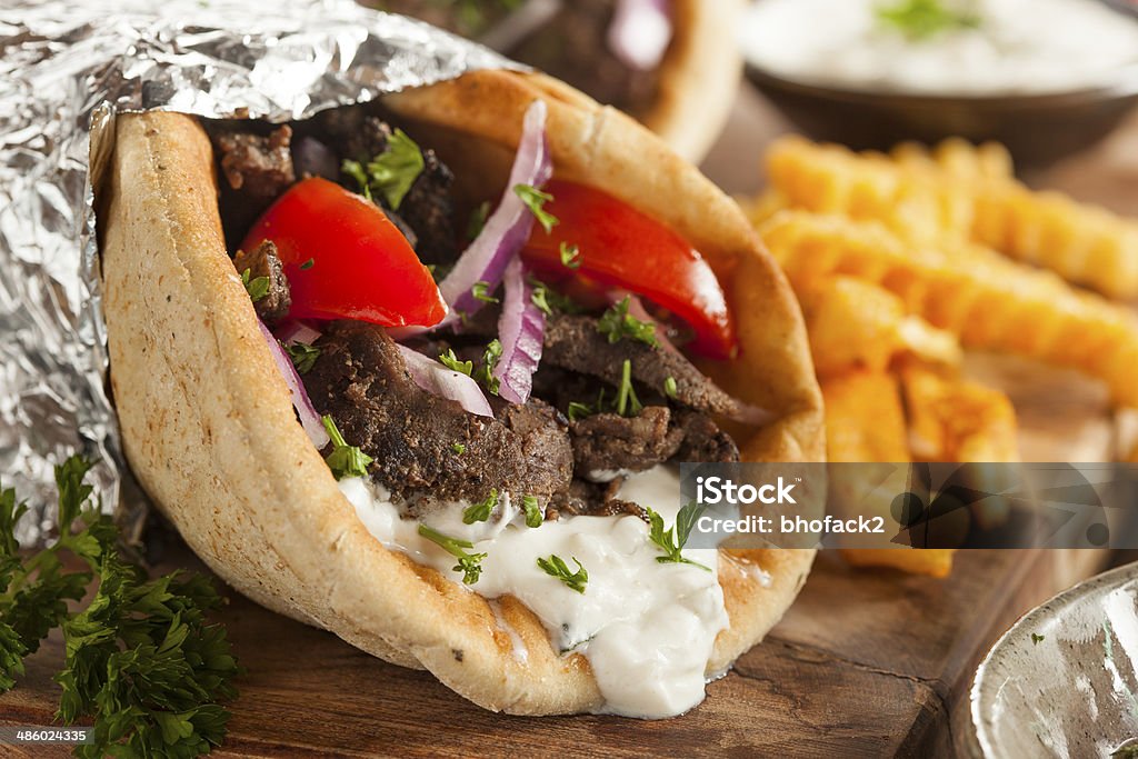 Homemade Meat Gyro with French Fries Homemade Meat Gyro with Tzatziki Sauce, tomatos and French Fries Greek Food Stock Photo