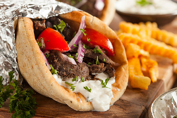 Homemade Meat Gyro with French Fries Homemade Meat Gyro with Tzatziki Sauce, tomatos and French Fries greek food stock pictures, royalty-free photos & images