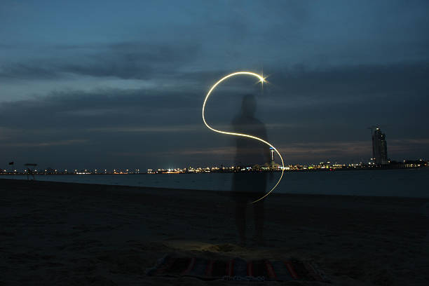 istock Young Man Light Painting the Letter 