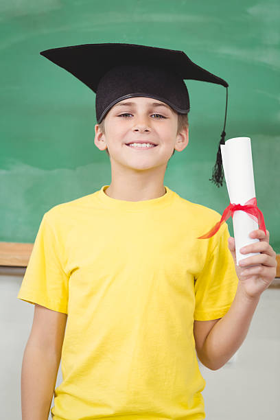 istock Smiling pupil with mortar board and diploma 486029236