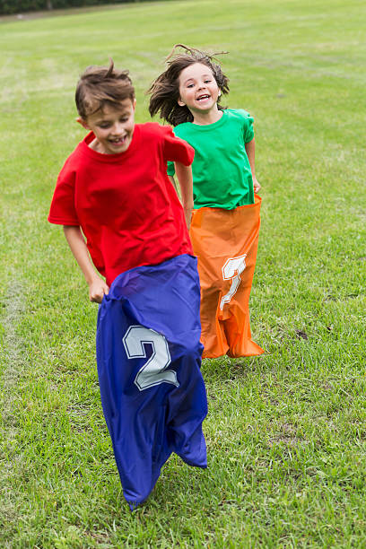 istock Two boys competing in a potato sack race 486029608