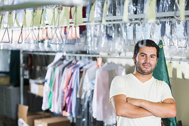 istock Confident Hispanic man working in dry cleaning store 486032366