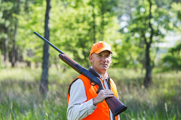 istock Man in woods hunting with shotgun 486032932