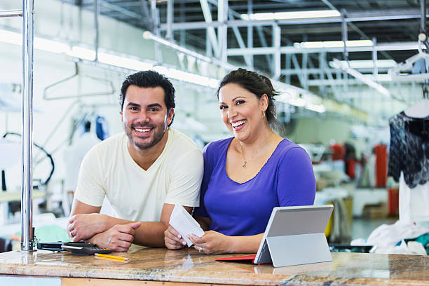 istock Hispanic small business owners, dry cleaner paying bills 486033118