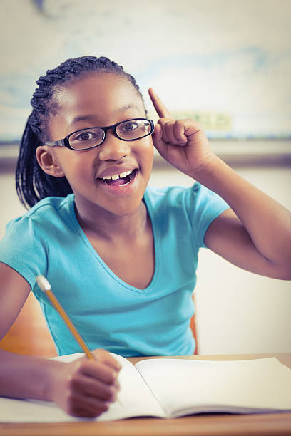 istock Cute pupil having an idea in a classroom 486033452