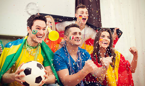 istock Multinational football supporters celebrating goal 486034455