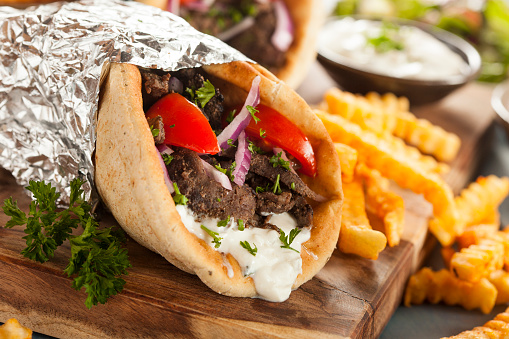 Homemade Meat Gyro with Tzatziki Sauce, tomatos and French Fries