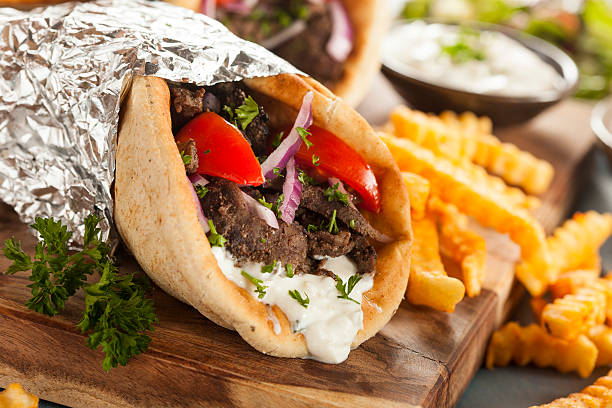 Homemade Meat Gyro with French Fries Homemade Meat Gyro with Tzatziki Sauce, tomatos and French Fries kebab photos stock pictures, royalty-free photos & images
