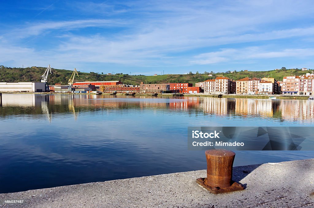 Erandio houses with Nervion river,  bollard and cranes Erandio houses with Nervion river,  bollard and cranes. Basque Country, Spain Barakaldo Stock Photo