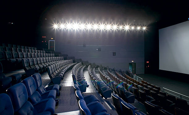 istock Cinema interior with lights on. Chairs and screen. 486038715