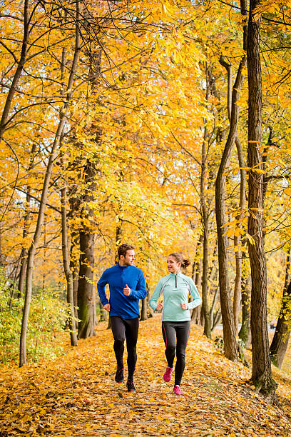 Young people jogging together in nature stock photo