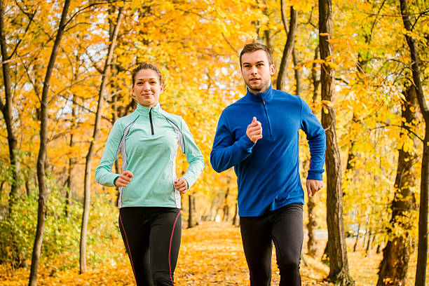 istock Couple jogging in autumn nature 486041964