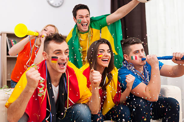 istock Multinational football supporters celebrating a goal 486043365