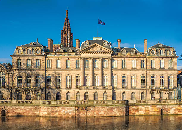 Palais Rohan, Strasbourg, France Strasbourg, France  - December 29, 2013: Palais Rohan on banks of L'ille river. Beautiful edifice of public building. People walking by. Recognisable persons, Public building  petite france strasbourg stock pictures, royalty-free photos & images
