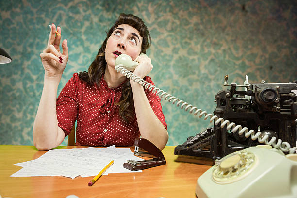 istock young Secretary smoking a cigarette while talking on the phone, 486044381