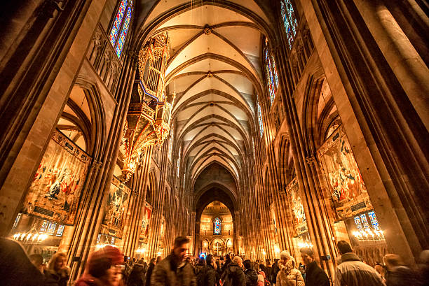 Interior of the Notre Damme de Strasbourg Strasbourg, France - December 29, 2013: Tourists and Pilgrims inside the Notre Dame de Strasbourg. Lot of  people visible and recognisable persons. Interior of the Basilica notre dame de strasbourg stock pictures, royalty-free photos & images