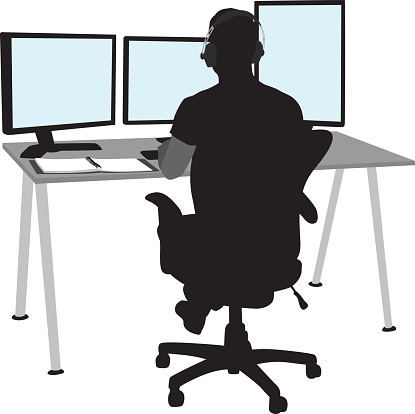A vector silhouette illustration of a man sitting at his computer work station.  He wears headphones and faced three computer monitors.