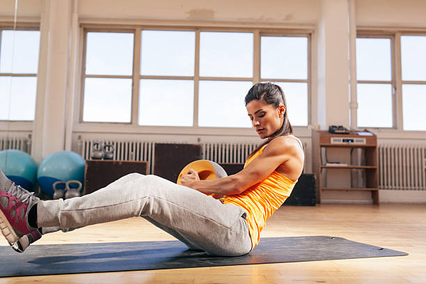 istock Young woman doing gym workout at gym 486047740