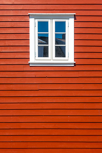 Window of traditional red wooden houses, rorbuer in the small fishing village of Nusfjord, Lofoten islands, Norway.