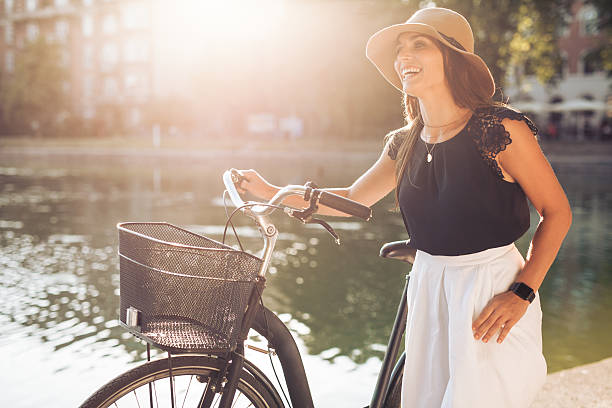 istock Happy woman at the park with a bicycle 486051198