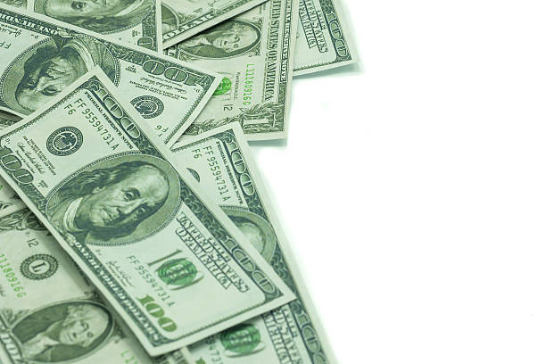 istock One hundred dollars and one dollars pile as background. 486053069