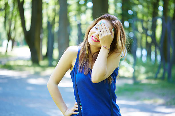 istock beautiful girl in a park smiling 486053604