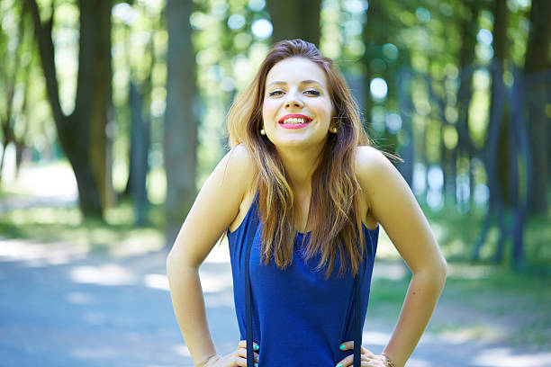 istock beautiful girl in a park smiling 486053800