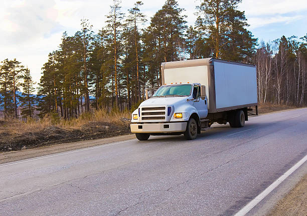 istock Truck driving on country road 486054182