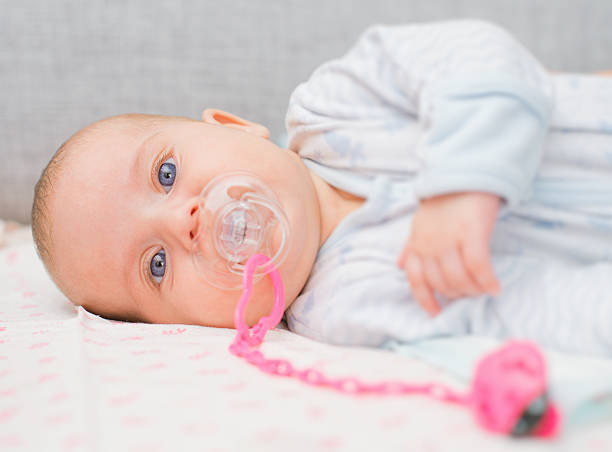 istock Newborn little baby with dummy on the bed. 486054928