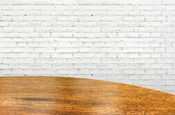 istock Empty wood round table and white brick wall in background. 486055204
