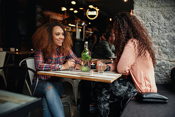 istock Two women sitting in a cafe talking 486055844