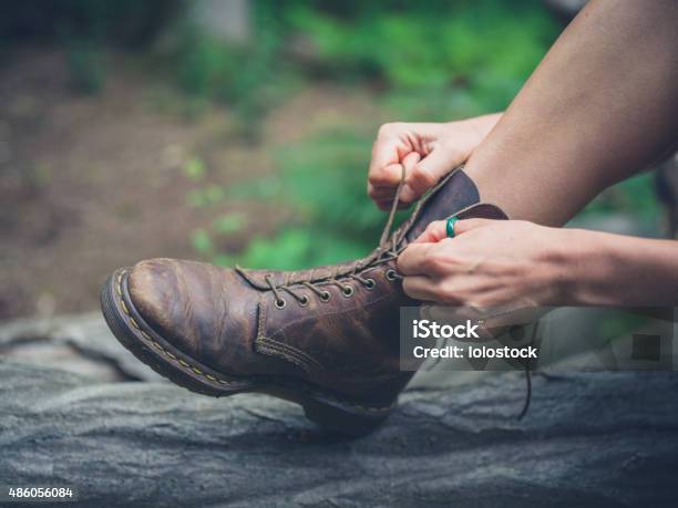 Young Woman Tying Her Boots In Forest Stock Photo - Download Image Now - 2015, Activity, Adult