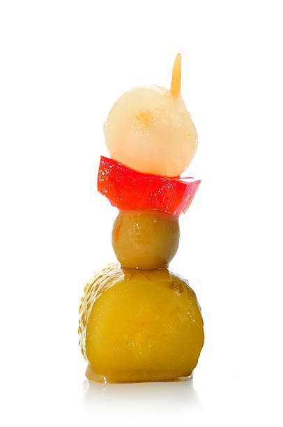 spanish banderilla, skewer with pickles a spanish banderilla, a skewer with different pickles, such as olive, garlic, cucumber, onion and red pepper banderilla stock pictures, royalty-free photos & images