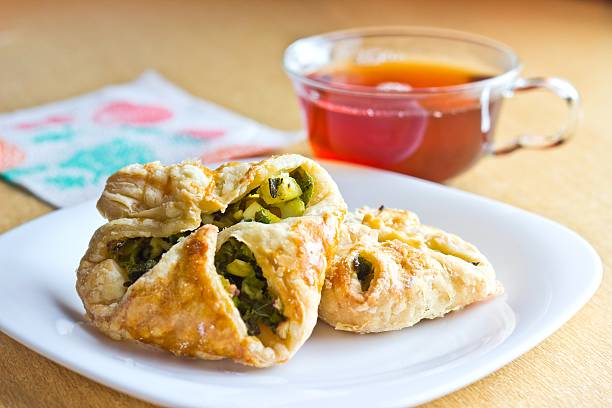 Fresh baked homemade puff pastry cakes with cup of tea