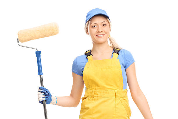 istock Young female house painter in a yellow overall 486058818