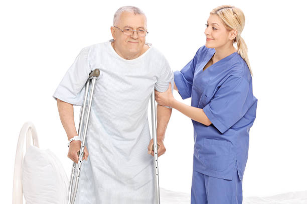 istock Young female nurse helping a senior patient with crutches 486058842