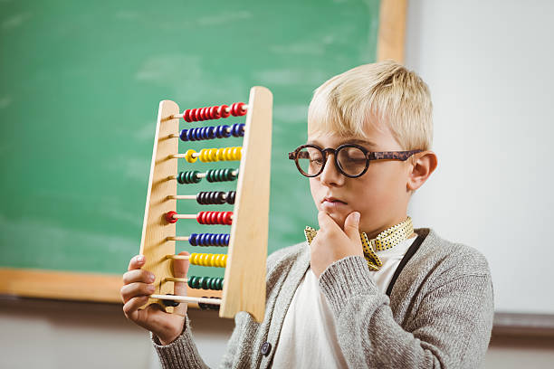istock Pupil dressed up as teacher holding abacus 486059604