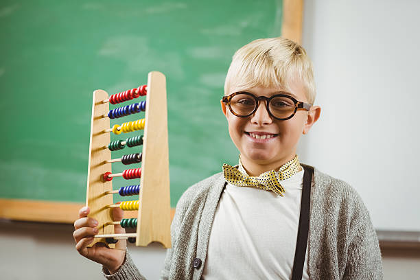 istock Smiling pupil dressed up as teacher holding abacus 486059614