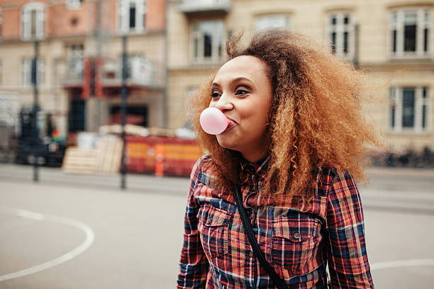istock African woman blowing bubble gum 486059622